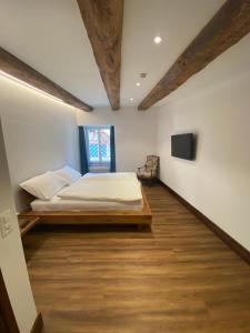 a bedroom with a bed, a desk and a window at Hotel Rheinfels in Stein am Rhein