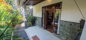 an entrance to a house with a glass door at Villa Esa Ubud in Ubud