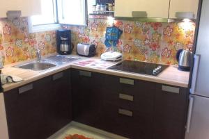 A kitchen or kitchenette at Flora's Boutique Apartment at the heart of Corfu