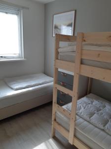 a bedroom with two bunk beds and a window at Appartement, Kaap 123 - Ameland in Hollum