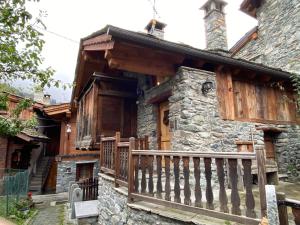 a log cabin with a porch and a balcony at Chalet Cretaz in Valtournenche