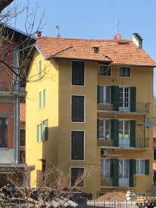 een geel gebouw met een rood dak bij Cà del Cerin in Trivero