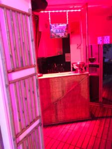 a red kitchen with a counter and a red light at Gites N Spa in Tourcoing