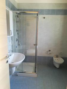 a bathroom with a shower and a sink and a toilet at Zio Tonino in Termoli +26 photos