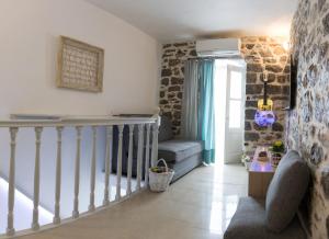 a living room with a staircase and a stair case at Sokaki House in Hydra