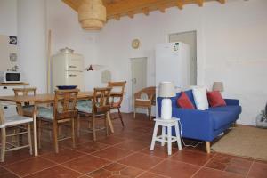 a living room with a blue couch and a table at The Little Olive Quinta in Alvaiázere