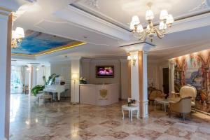 a lobby with a ceiling with a painting on it at Izida Palace Apartments in Sunny Beach