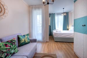 a living room with a couch and a bedroom at Izida Palace Apartments in Sunny Beach +48 photos