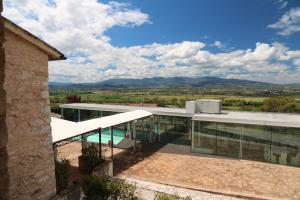 a house with a balcony with a view of the mountains at Corte Fratini Appartamenti in Trevi