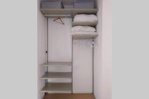 a walk in closet with white towels and a mirror at Casa Bianca - Luxury with balcony in the city Centre in Taormina
