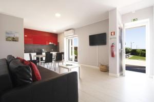 a living room with a couch and a dining room at Villa Bellevue 4 in Albufeira