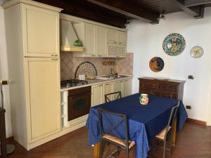 a kitchen with a table with a blue table cloth on it at Napoli Centro Antico in Naples