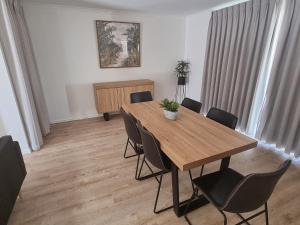 a dining room with a wooden table and chairs at Mildura Holiday Homes - 15th Street in Mildura