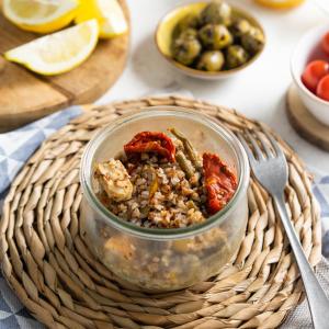 a jar ofinoa and vegetables on a table with a fork at Ibis Sarlat Centre in Sarlat-la-Canéda