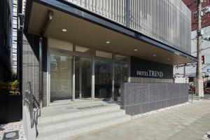 a store front with steps in front of a building at Hotel Trend Kyobashi Ekimae in Osaka