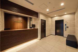a lobby of a hotel with a reception desk at Hotel Trend Kyobashi Ekimae in Osaka