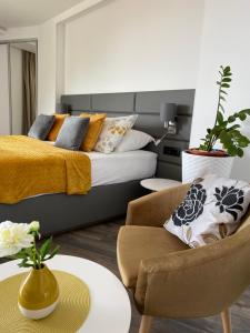 a bedroom with a bed and a couch and a chair at Villa Lenka and Mate Ivanac in Brela