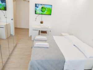 a white room with a large bed with two towels at Modern Room with private bathroom in Trento