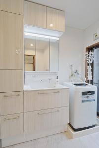 een witte keuken met een wastafel en een aanrecht bij Mon Petit Chat in Kanazawa