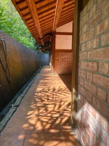 a brick building with a wooden roof and a brick sidewalk at Bamboo House in Zhushan