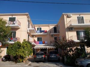 a large building with cars parked in a parking lot at Kohyli in Lefkada Town