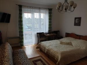 sypialnia z łóżkiem, biurkiem i oknem w obiekcie RENESANS we Władysławowie
