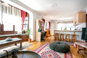 a living room with a couch and a table at Beach House Apartment in Side