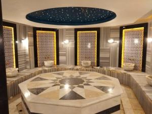 a large room with a table in the middle of it at EMPIRE RESIDENCE ALANYA in Alanya