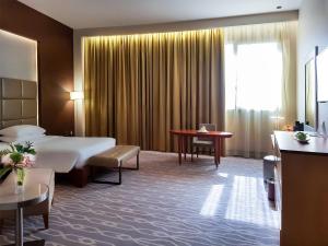 Postel nebo postele na pokoji v ubytování Millennium Hail Hotel