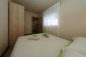 Posteľ alebo postele v izbe v ubytovaní APARTMAN ZARA