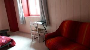 Posezení v ubytování Chambre spacieuse et lumineuse
