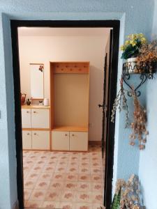 a doorway into a room with a dresser and a mirror at Bela golobica Bogojina in Bogojina +9 photos