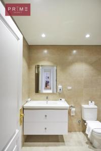 a bathroom with a white sink and a toilet at Prime Select Arkadia Nile View in Cairo