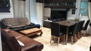 a living room with a table and a couch at JOLIE MAISON CONTEMPORAINE St Emilion in Néac