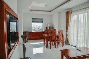 a living room with a dining room table and chairs at Lam Hồng Apartment & Hotel in Nha Trang