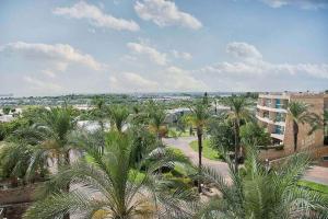 an aerial view of a park with palm trees and a building at Caesarea Sea View Suite in Caesarea