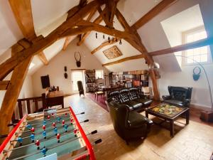 a living room with a pool table in a attic at Maison des Arts Francueil in Francueil