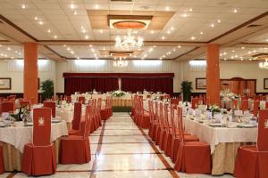 a banquet hall with tables and chairs in a room at Hotel Begoña Park in Gijón