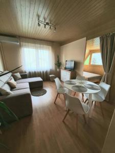 a living room with a couch and a table at Apartman Ilike in Balatonfüred