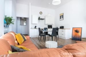 a living room and kitchen with a couch and a table at Zamkowa Apart in Cieszyn