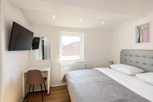 a white bedroom with a bed and a window at Neretva Valley Apartments - Heated Pool in Metković +47 photos