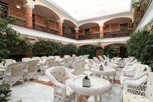 an empty patio with tables and chairs in a building at Hotel Begoña Park in Gijón