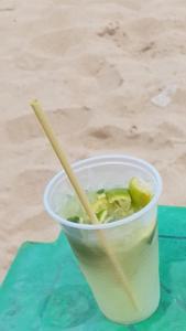 a drink in a plastic cup on a table at Guest Apartment Paulo in Recife
