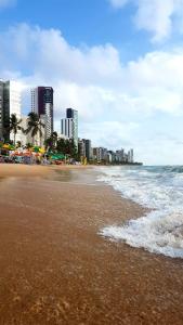 a beach with buildings and the ocean and a city at Guest Apartment Paulo in Recife