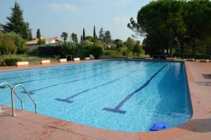 a large swimming pool with blue water at Casa Savoia in Bardolino