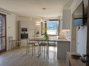 a kitchen with a table and chairs in a room at Casa Pina in Tignale