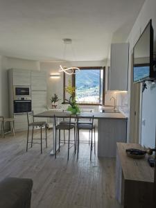 a kitchen and dining room with a table and chairs at Casa Pina in Tignale +29 photos