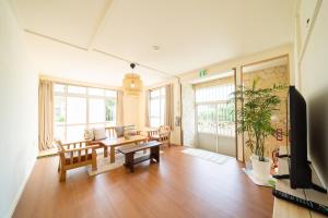 a living room with a couch and a table at 古民家宿 大海 in Uruma