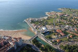 an aerial view of a city and the beach at Hotel Begoña Park in Gijón