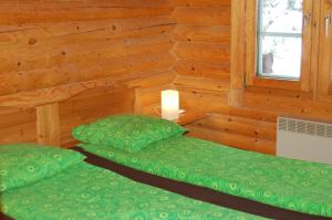 2 camas en una cabaña de madera con ventana en Chalet de Llivia en Estavar